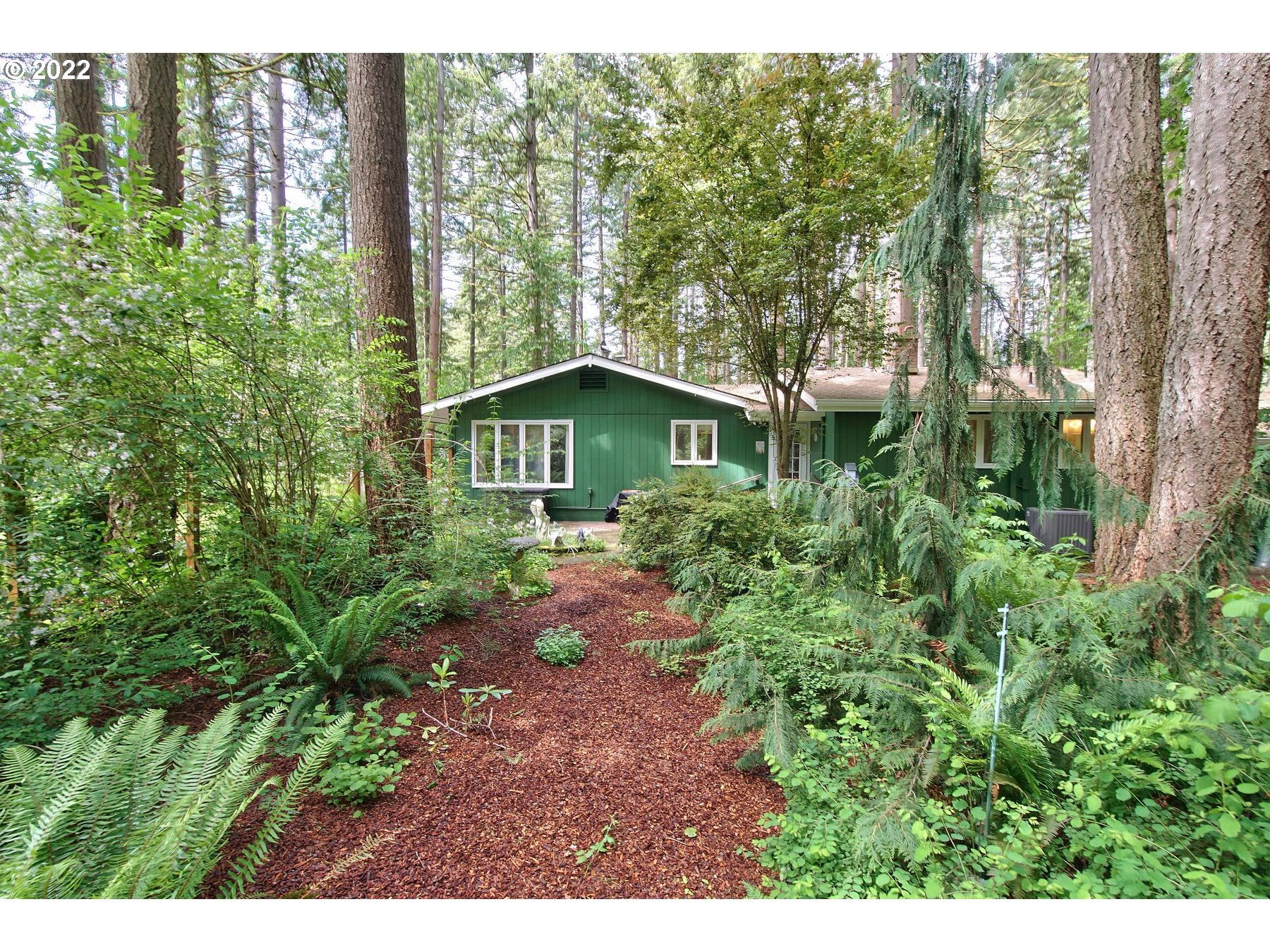23590 South Beatie Road Oregon City, OR 97045 - Photo 3 of 32 a yellow house with lots of trees