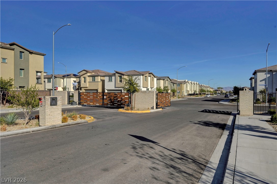 6924 Spicy Merlot Street North Las Vegas, NV 89086 - Photo 79 of 83 Secure community entrance with contemporary gate design, ensuring resident privacy.