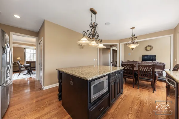 a kitchen with a stove and wooden floor