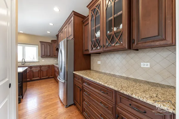 a view of a kitchen with wooden floor and cabinets
