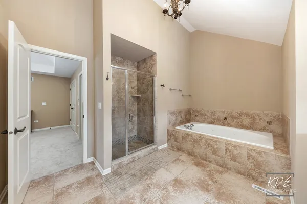 a spacious bathroom with a bathtub and a shower
