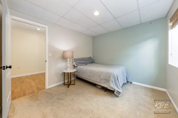 a bedroom with a bed and a night stand