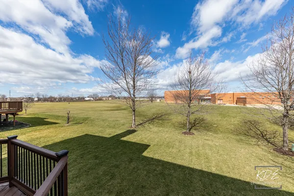 an aerial view of a house with outdoor space and lake view in back
