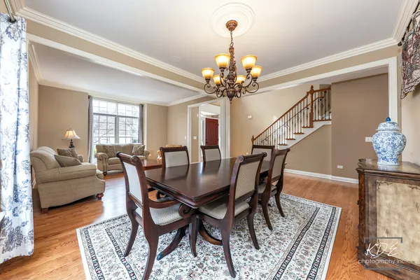a view of a dining room with furniture wooden floor and chandelier