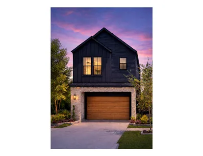 a view of a house with a small yard and garage