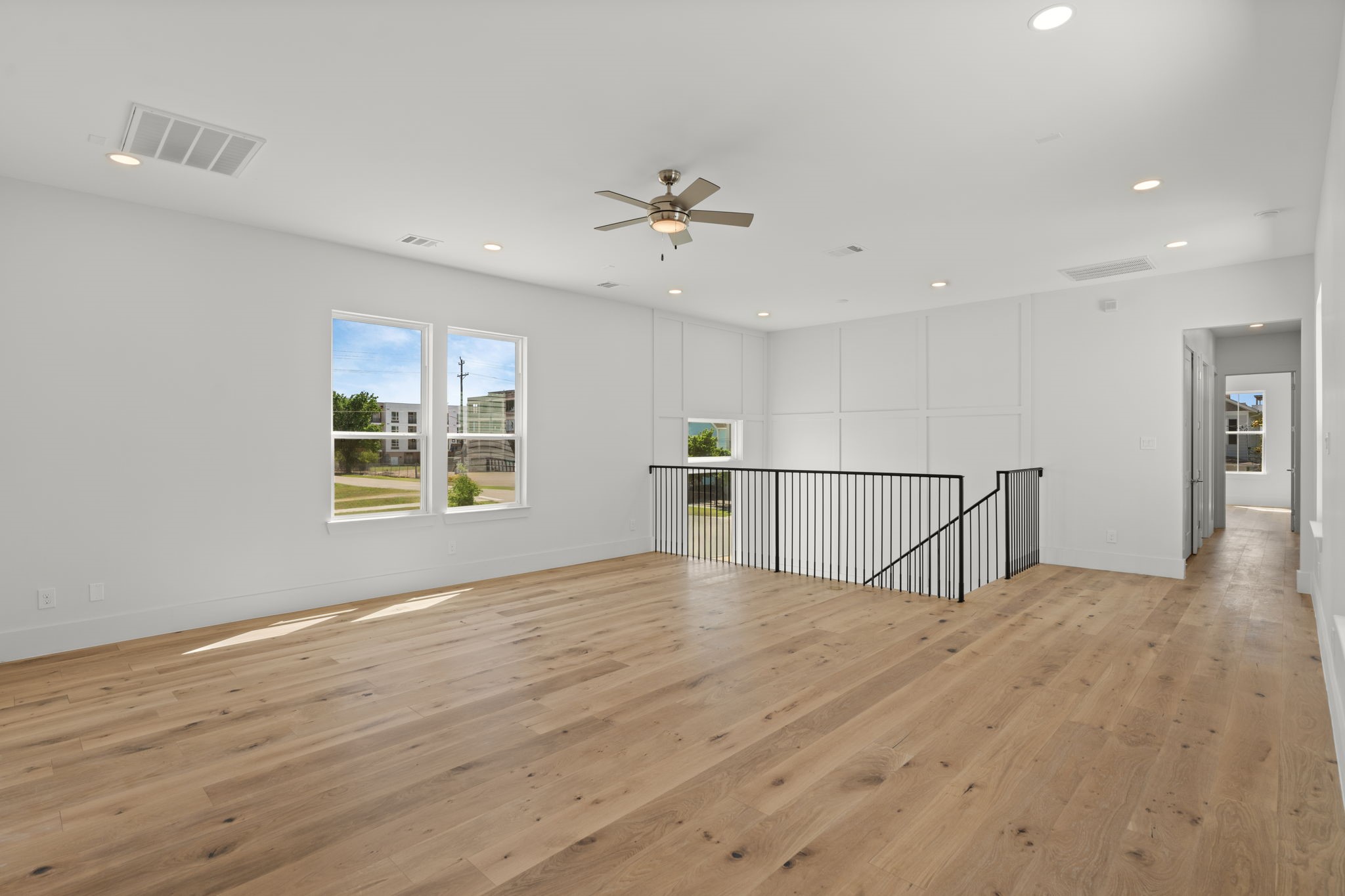 710 Waverly Street, Unit E Houston, TX 77007 - Photo 11 of 19 a view of an empty room with wooden floor and a window