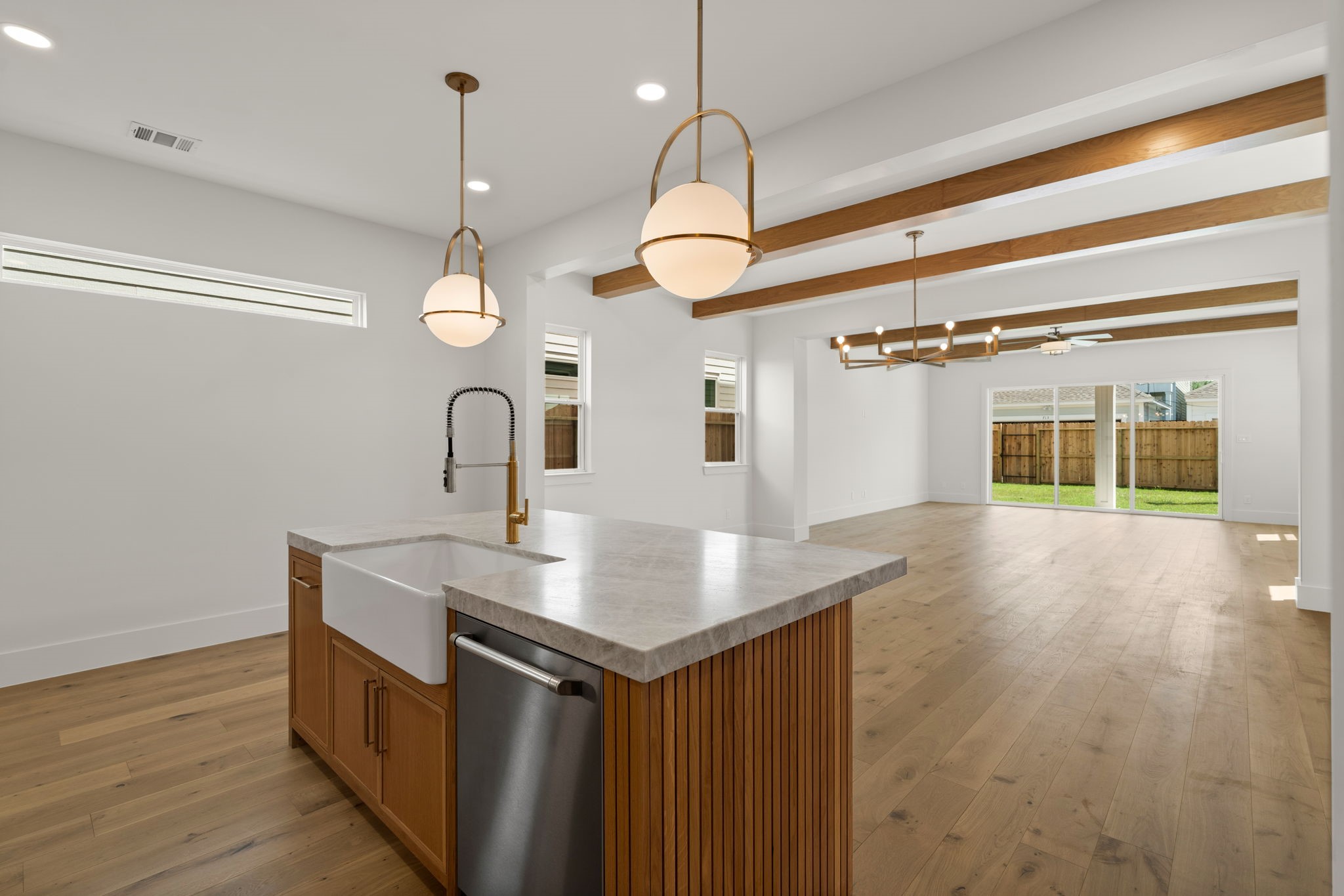 710 Waverly Street, Unit E Houston, TX 77007 - Photo 2 of 19 a kitchen with a sink cabinets and wooden floor