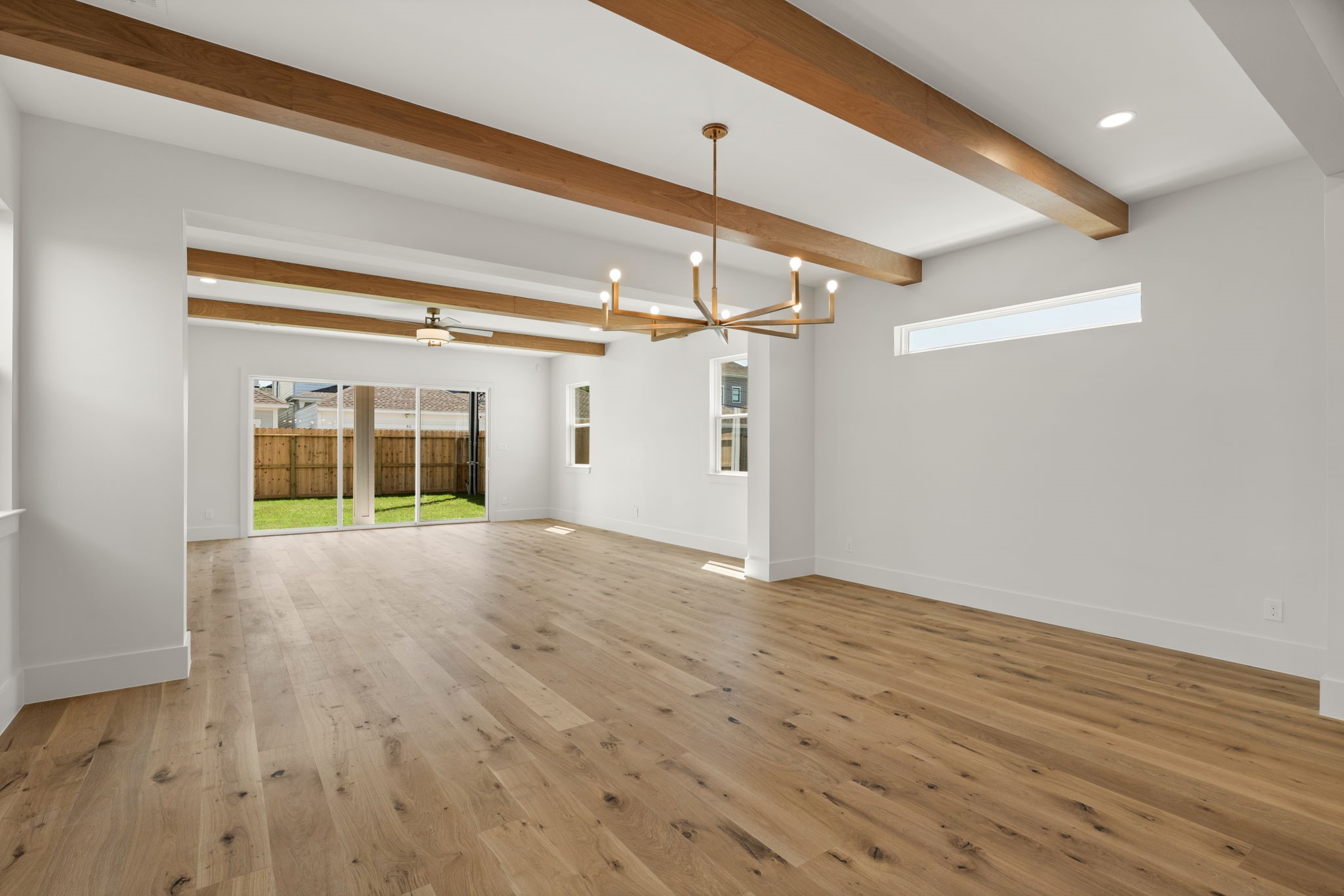 710 Waverly Street, Unit E Houston, TX 77007 - Photo 4 of 19 a view of empty room with wooden floor and fan