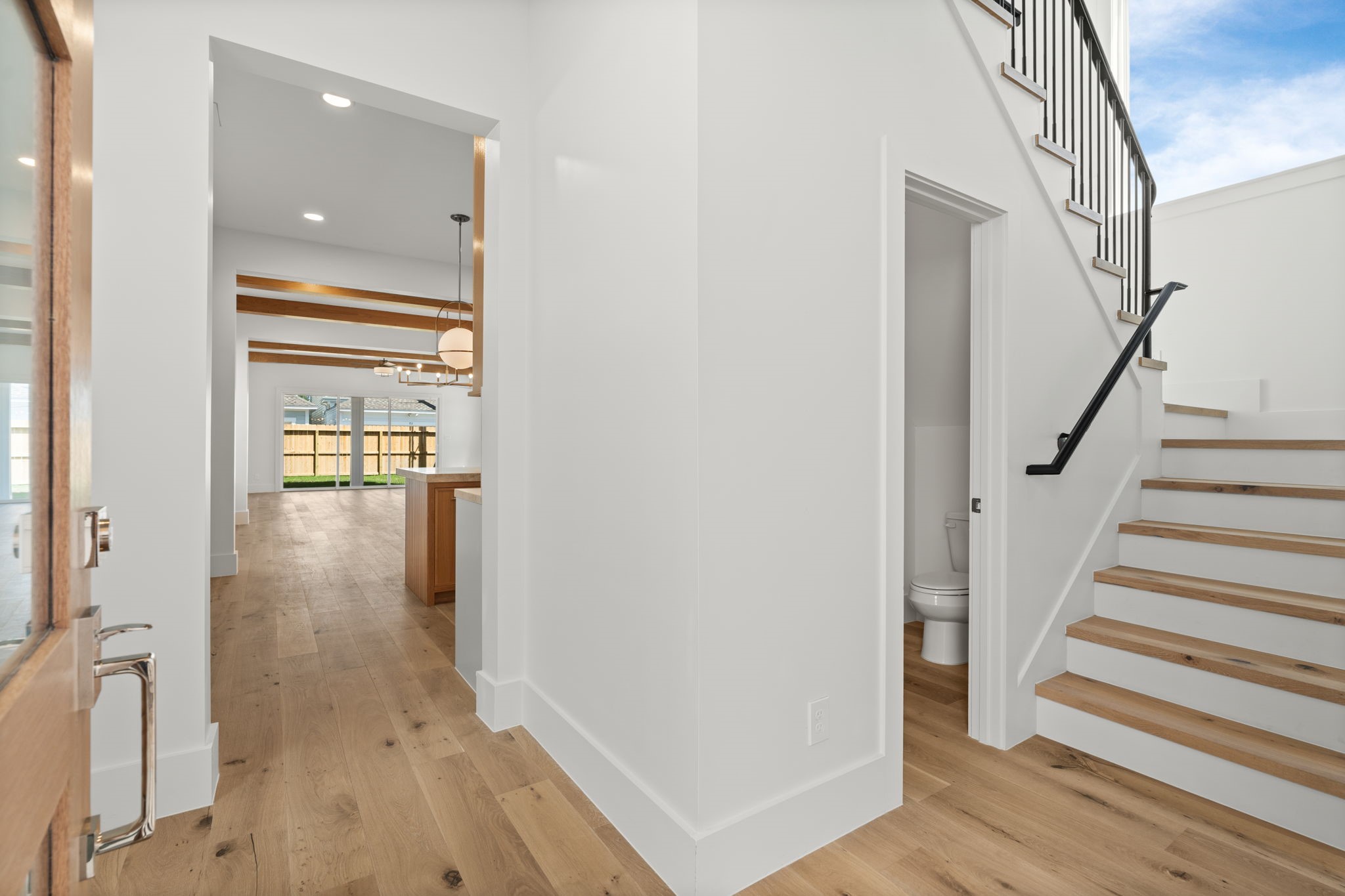 710 Waverly Street, Unit E Houston, TX 77007 - Photo 6 of 19 a view of a hallway with wooden floor and staircase