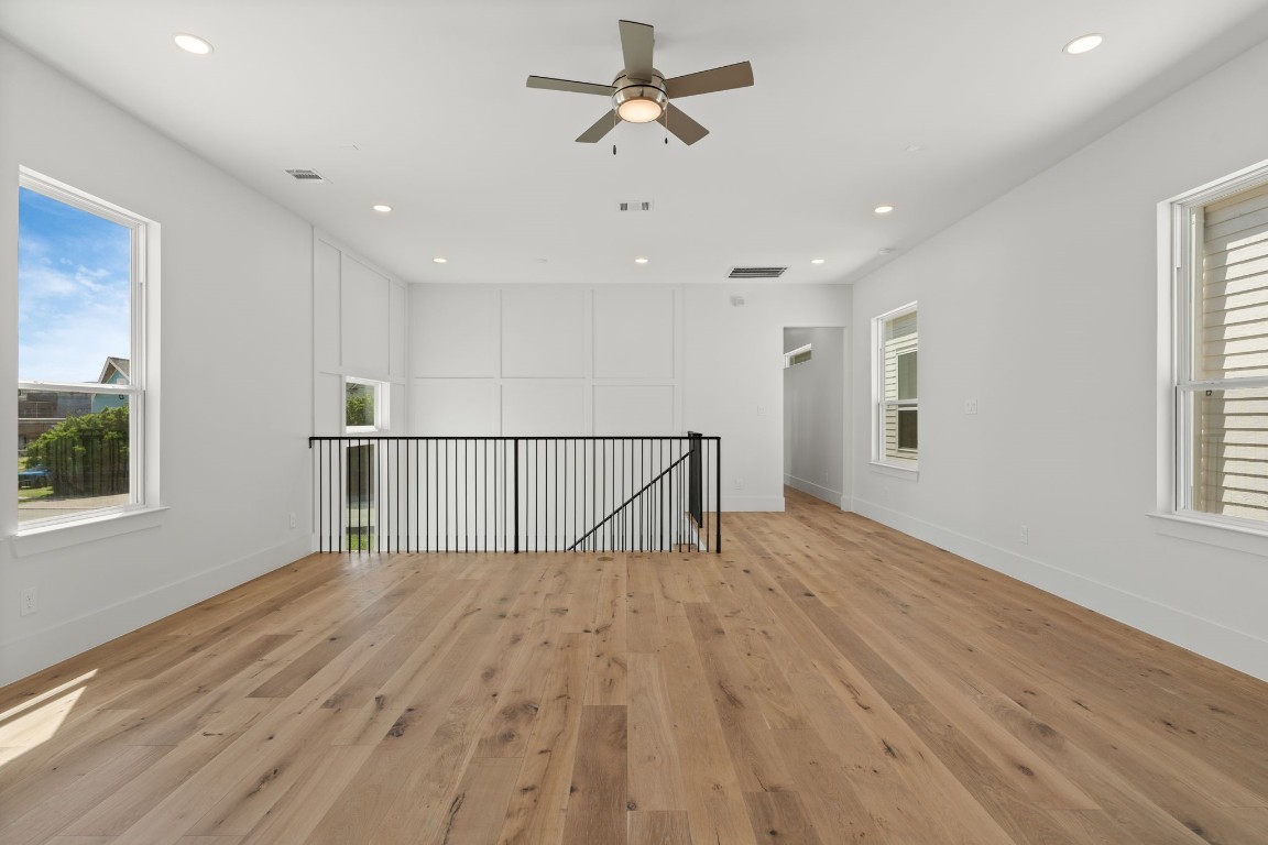 710 Waverly Street, Unit E Houston, TX 77007 - Photo 10 of 19 a view of a bedroom with wooden floor and a window