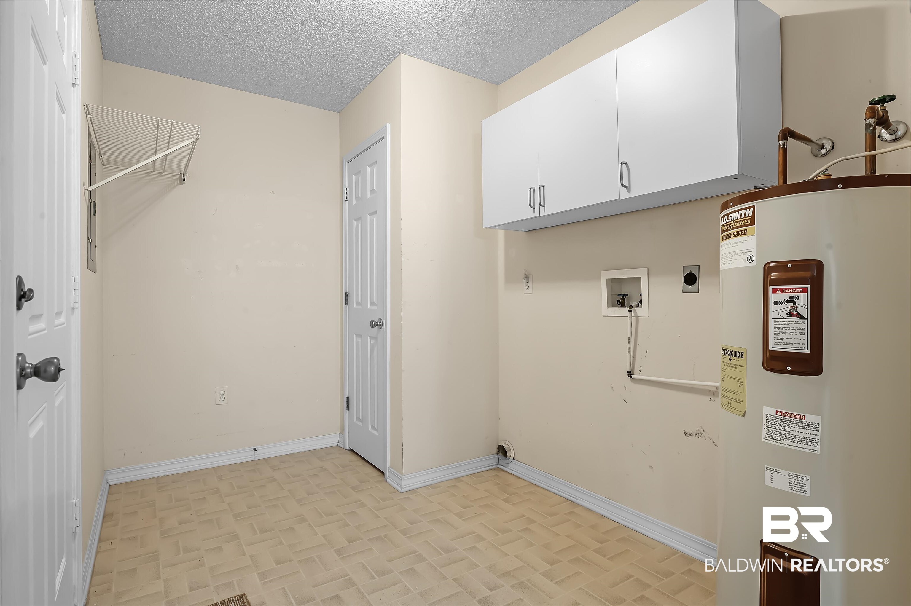 1502 Mulberry Lane Foley, AL 36535 - Photo 19 of 45 Washroom with a textured ceiling, hookup for a washing machine, cabinets, water heater, and electric dryer hookup
