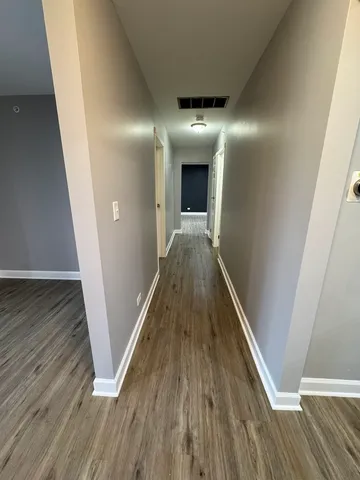 a view of gallery with wooden floor