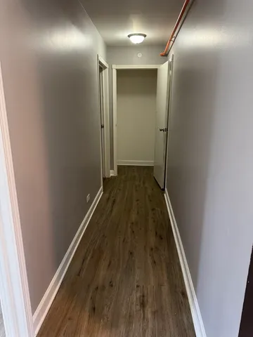 a view of hallway with wooden floor