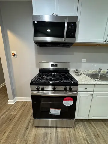 a stove top oven sitting inside of a kitchen