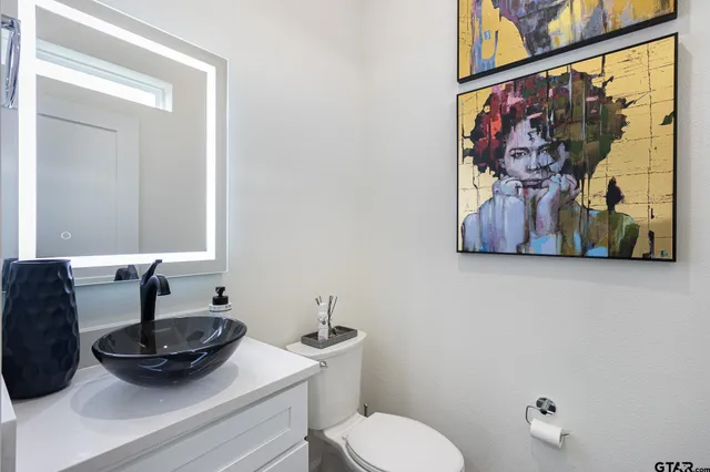 a bathroom with a sink a mirror and a window