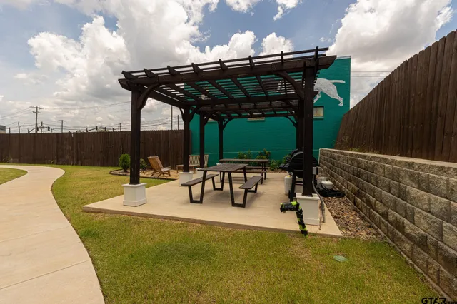 a view of a patio with a table and chairs with wooden floor