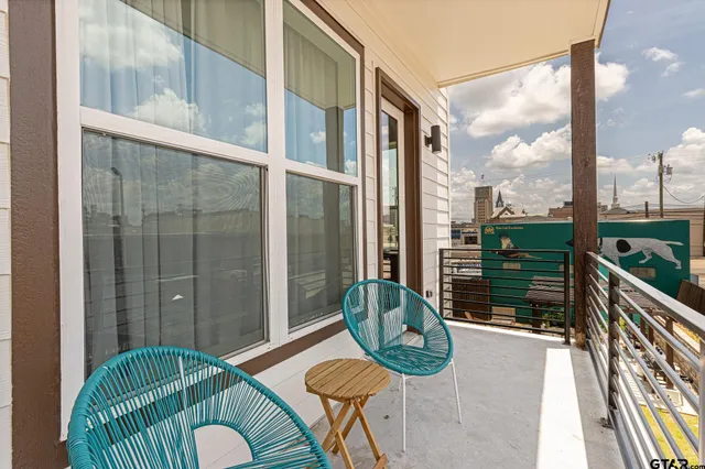 a balcony with furniture and a rug