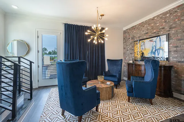 a living room with furniture a rug and a wall painting