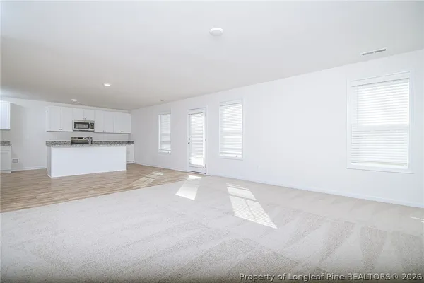 a view of empty room with kitchen appliances