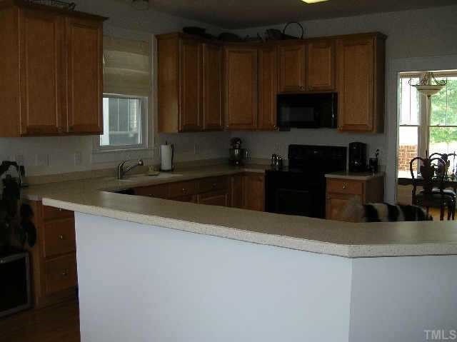 3412 Falls River Raleigh, NC 27614 - Photo 3 of 10 Kitchen with Solid Surface & Eat at Bar