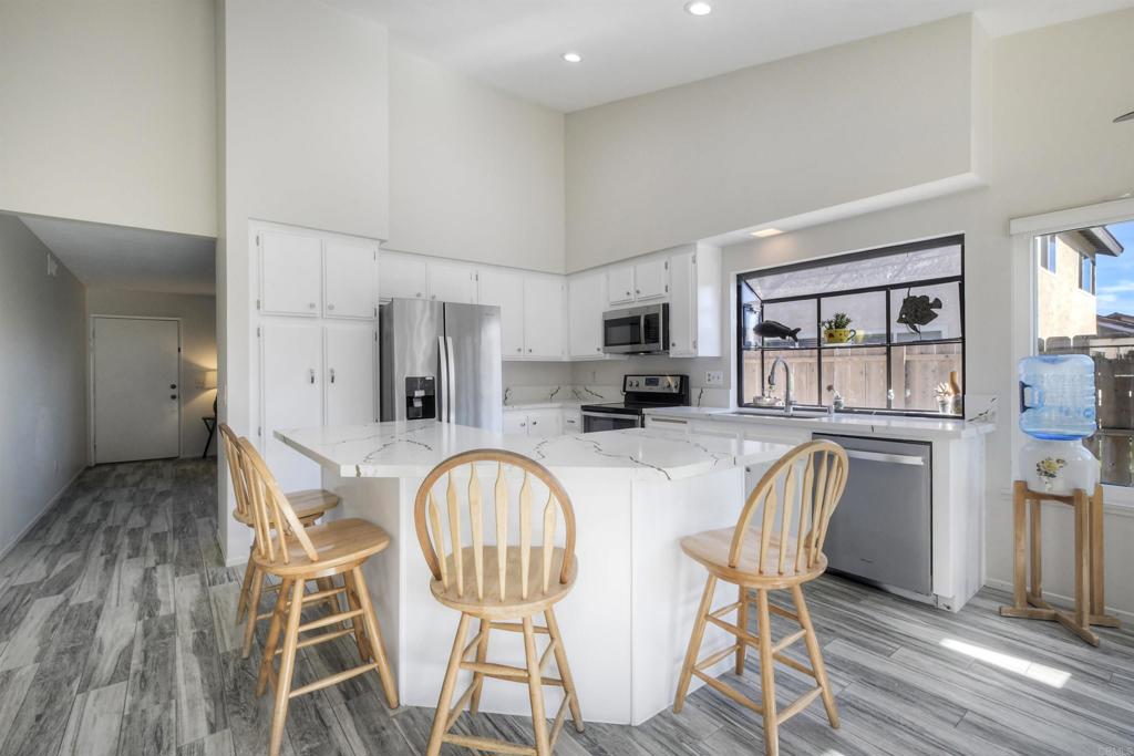 4413 Point Degada Oceanside, CA 92058 - Photo 45 of 46 a dining room with furniture a window and wooden floor