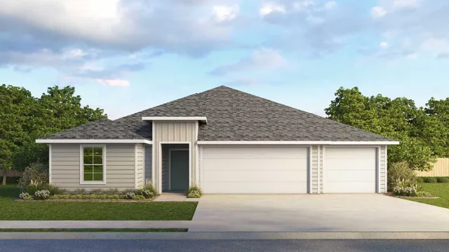 a front view of house with garage and trees