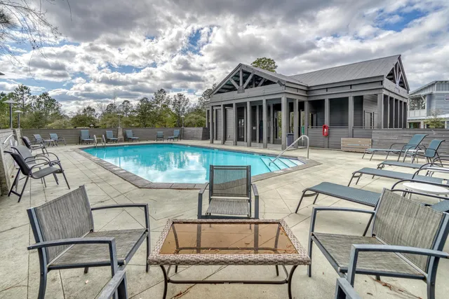 a view of a house with swimming pool and sitting area