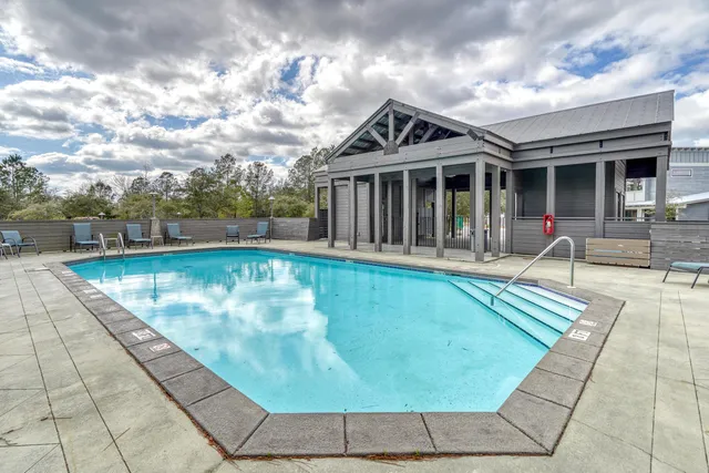 a view of a house with swimming pool and sitting area