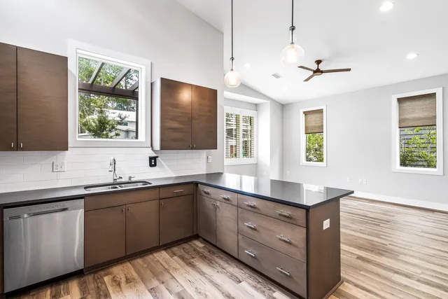 a kitchen with a sink window and cabinets