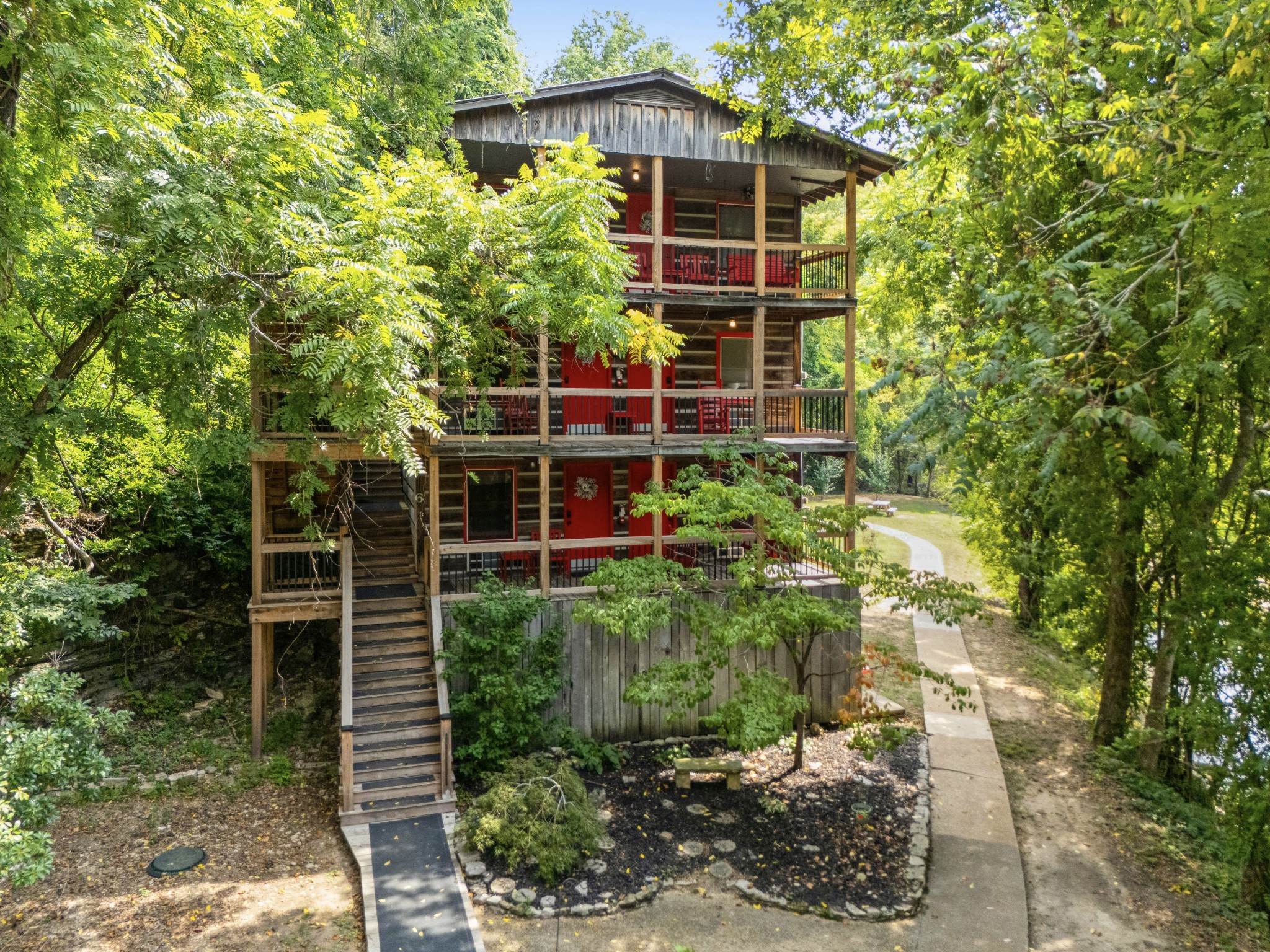 299 Natural Bridge Park Road Waynesboro, TN 38485 - Photo 42 of 63 a view of a house with a yard and potted plants