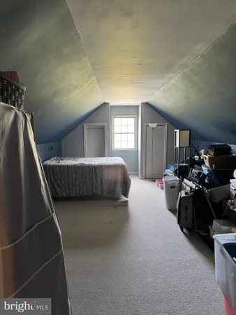 a bed room with a bed and a large mirror