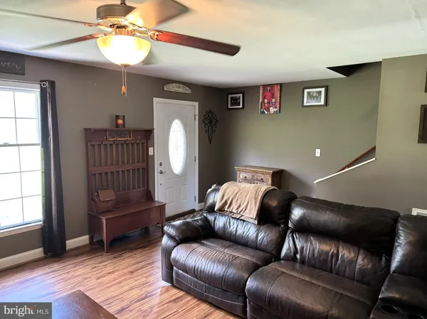 a living room with a couch and a chandelier