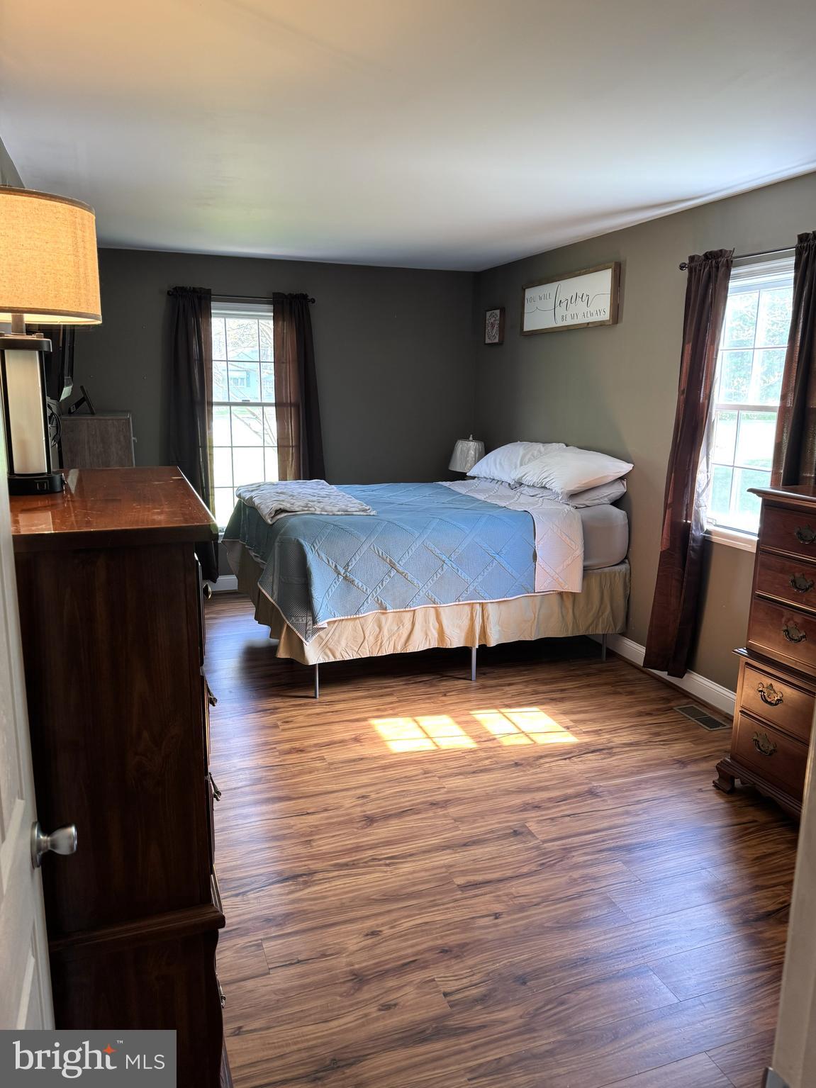 26210 Oak Grove Road Seaford, DE 19973 - Photo 10 of 33 a bedroom with a bed and wooden floor