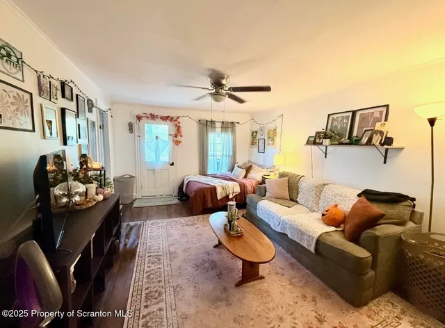 a living room with furniture and a chandelier