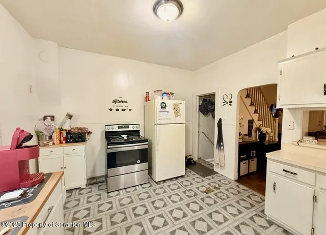a kitchen with stainless steel appliances granite countertop a refrigerator and a stove