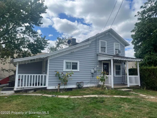 a view of a house with a yard and a garden