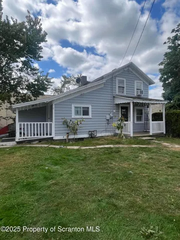 a front view of house with yard barbeque and outdoor seating