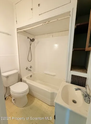 a bathroom with a sink a toilet and a bathtub