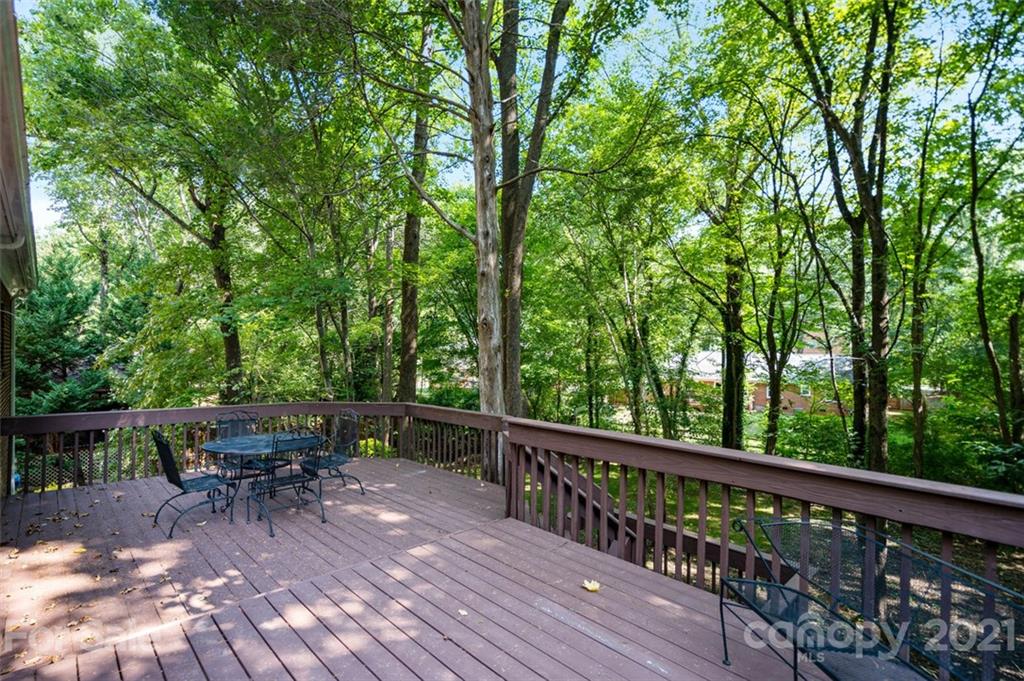 638 Trail Ridge Road Matthews, NC 28105 - Photo 29 of 36 a view of a deck with chairs and large trees