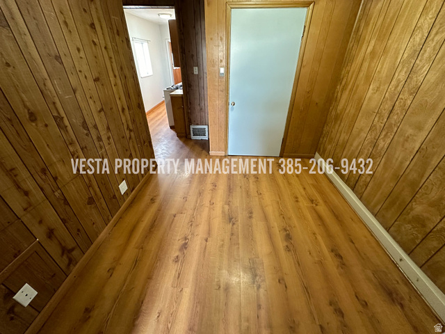 471 East 22nd Street Ogden, UT 84401 - Photo 11 of 12 Spare room featuring hardwood / wood-style flooring and wooden walls