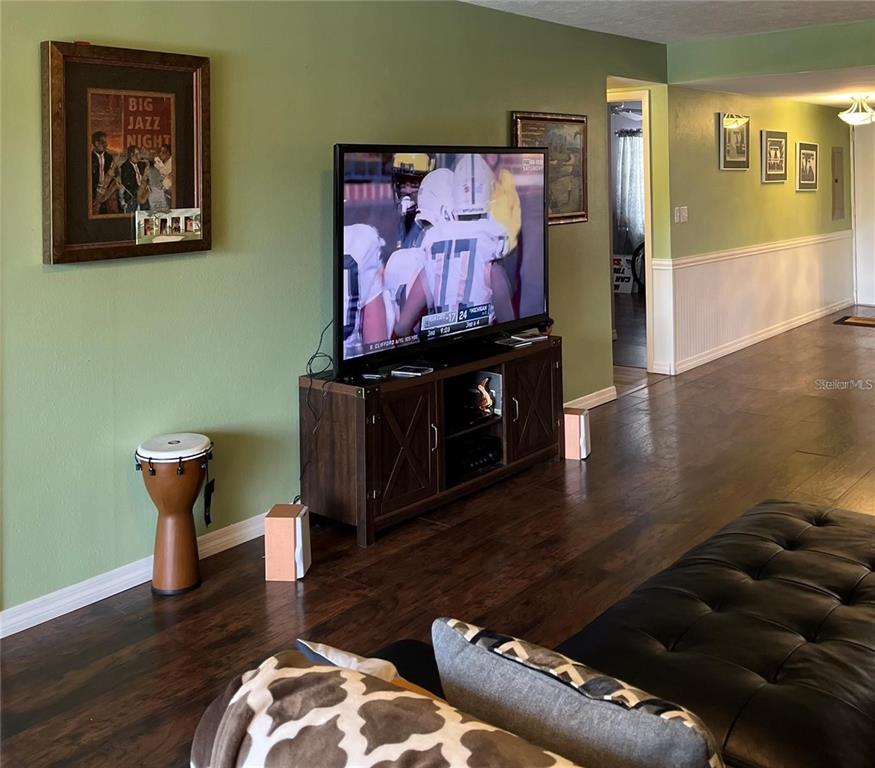 5640 Ferguson Court, Unit 2205 New Port Richey, FL 34652 - Photo 14 of 23 a living room with furniture and wooden floor