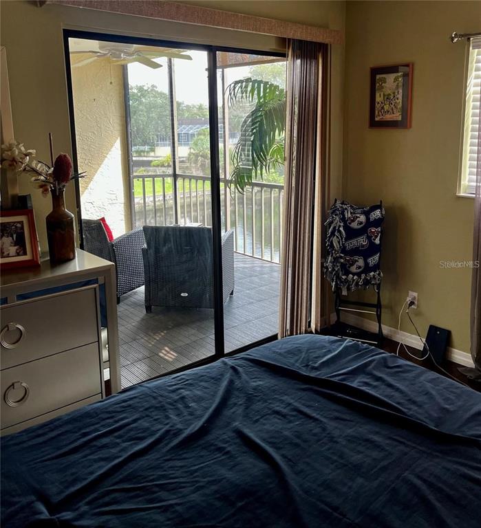 5640 Ferguson Court, Unit 2205 New Port Richey, FL 34652 - Photo 15 of 23 a bedroom with a bed and a window