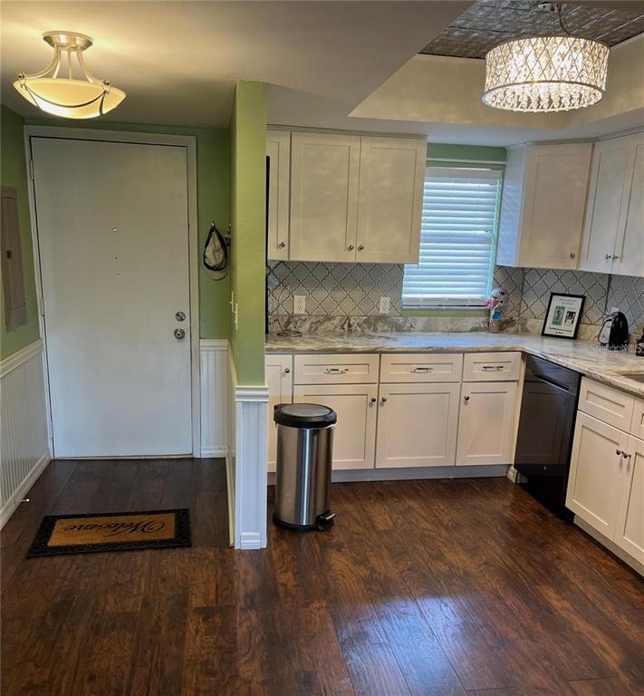 5640 Ferguson Court, Unit 2205 New Port Richey, FL 34652 - Photo 4 of 23 a kitchen with stainless steel appliances granite countertop a stove a sink and a microwave