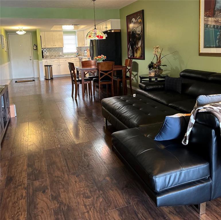 5640 Ferguson Court, Unit 2205 New Port Richey, FL 34652 - Photo 5 of 23 a living room with furniture and wooden floor
