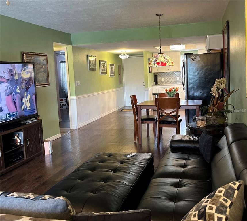 5640 Ferguson Court, Unit 2205 New Port Richey, FL 34652 - Photo 6 of 23 a living room with furniture and a flat screen tv
