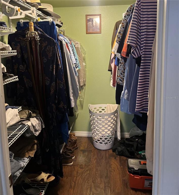 5640 Ferguson Court, Unit 2205 New Port Richey, FL 34652 - Photo 9 of 23 a view of walk in closet with clothes and shoes
