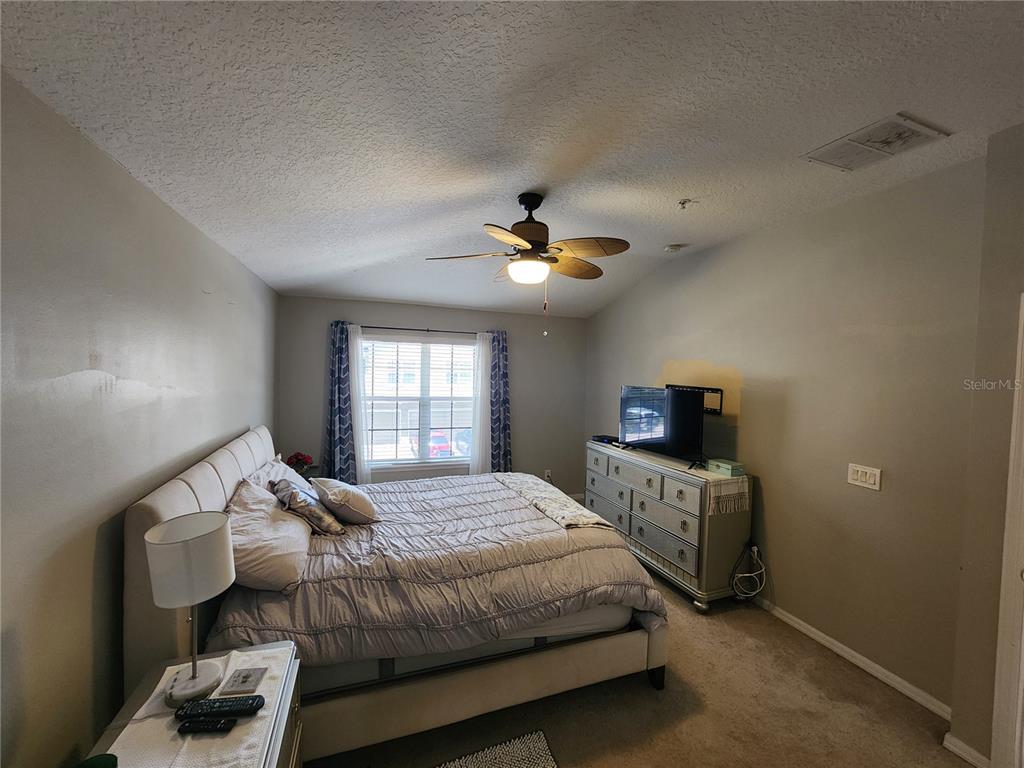 546 Climbing Ivy Court, Unit C Apopka, FL 32712 - Photo 14 of 26 a bedroom with a bed and window
