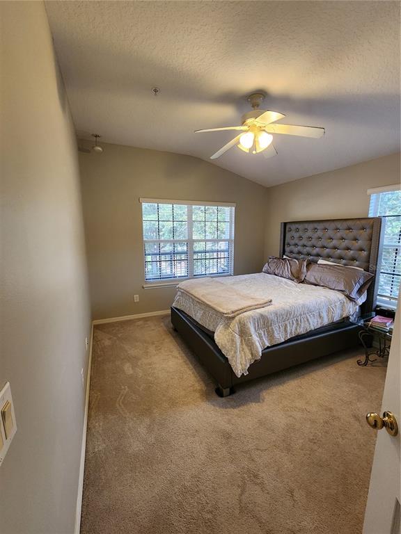 546 Climbing Ivy Court, Unit C Apopka, FL 32712 - Photo 20 of 26 a bedroom with a bed and window