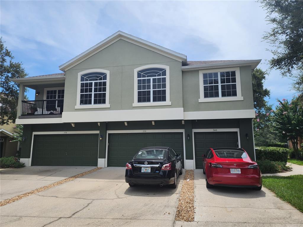 546 Climbing Ivy Court, Unit C Apopka, FL 32712 - Photo 2 of 26 a car parked in front of a house
