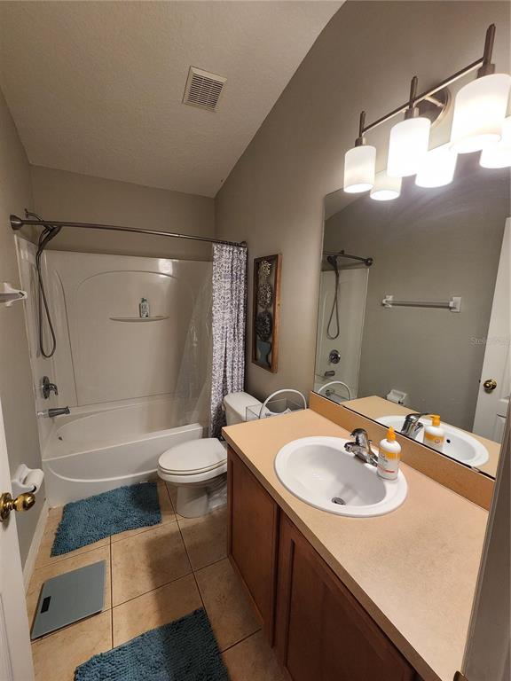546 Climbing Ivy Court, Unit C Apopka, FL 32712 - Photo 21 of 26 a bathroom with a sink a toilet and shower